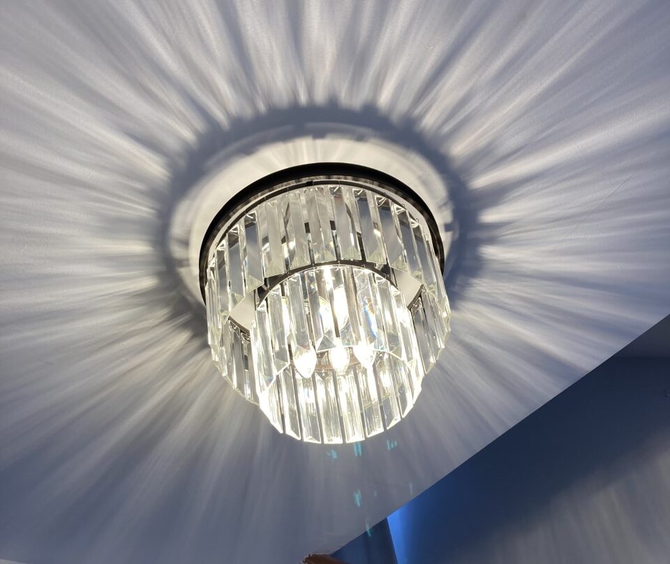 Crystal chandelier installation in a Christchurch home hallway